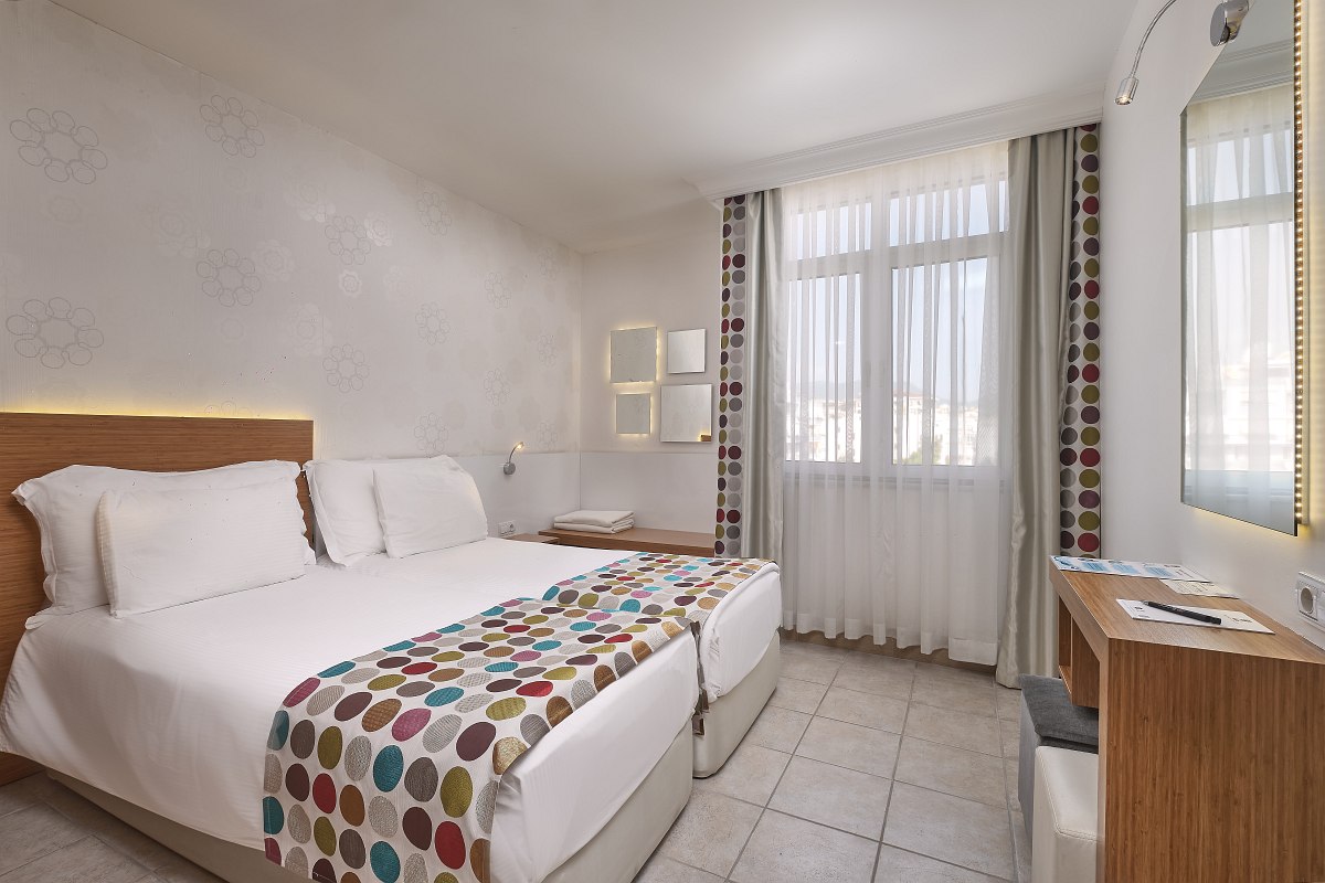 Hell eingerichtetes Zimmer mit zwei Einzelbetten, Sofa, Landblick, Wohnbereich und Schlafbereich, zwei Klimaanlagen, Nichtraucher Zimmer.