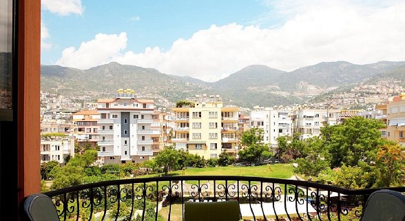 View of the pool with sun loungers and parasols
