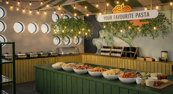 Garden restaurant surrounded by greenery with a view of the pool